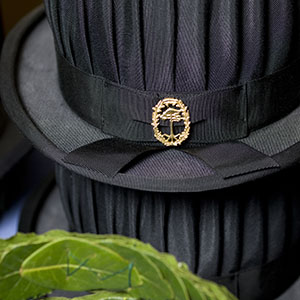 Black hat with forest college emblem. Photo.