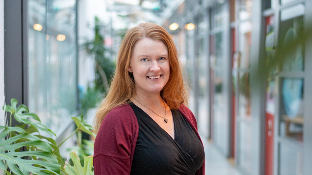 Portrait photo of a woman indoors.