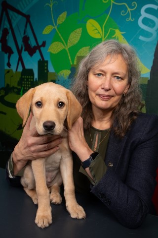 Maria Knutson Wedel with a puppy in her arms