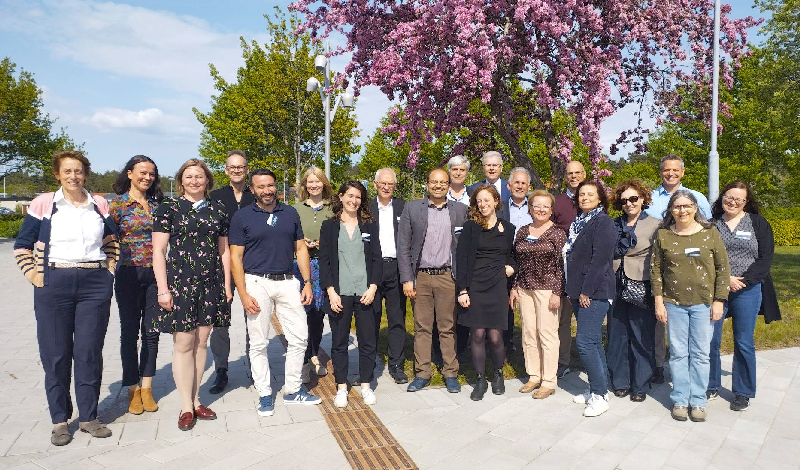 20 people in front of the camera outdoors. Photo.