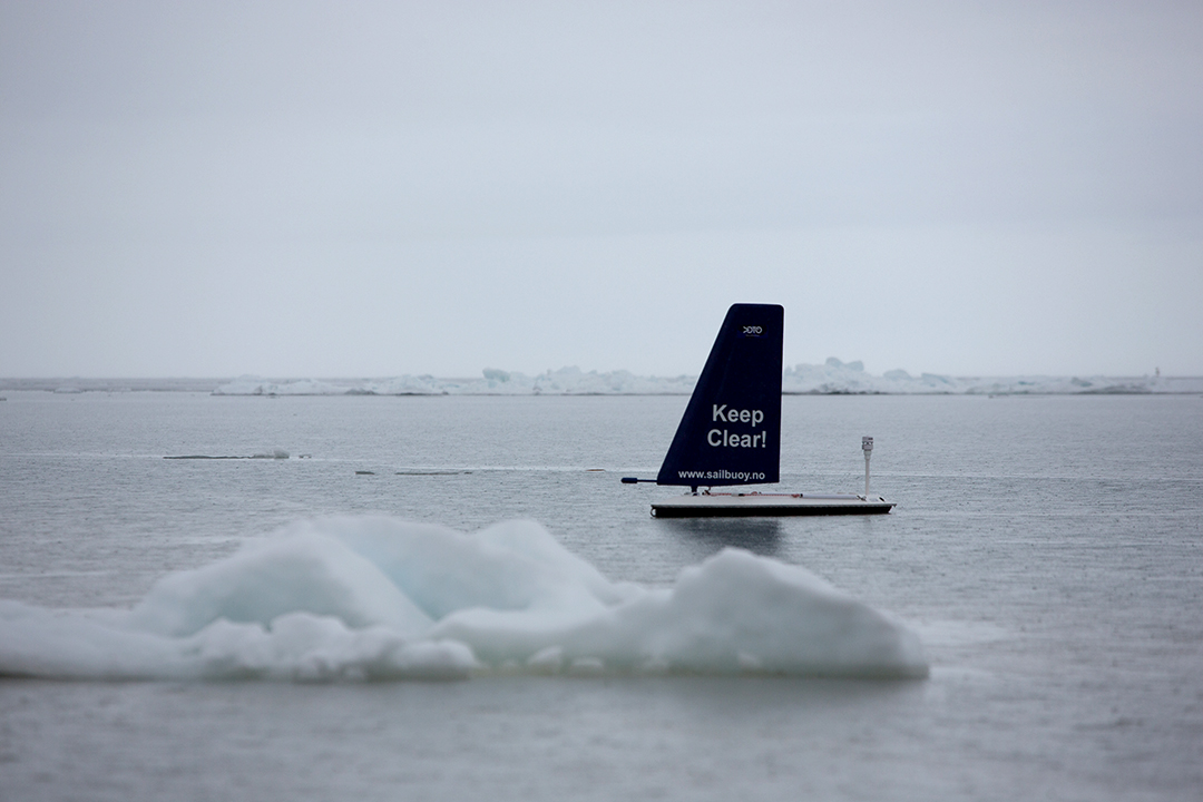 Small sailingboat on icy water