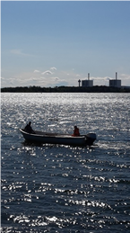 sky, sea and a boat with two people