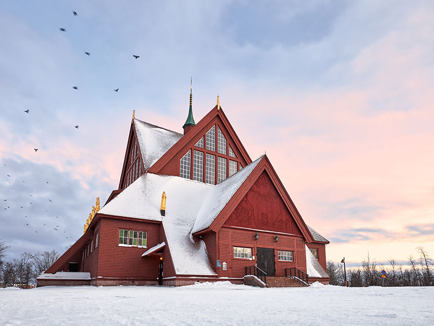 Red wooden church in Kiruna in winter. Photo.