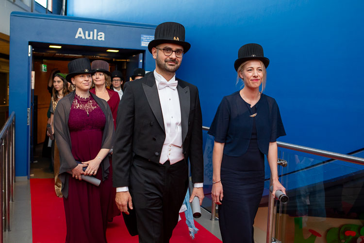 Picture of happy new doctors leaving the assembly hall in the procession.