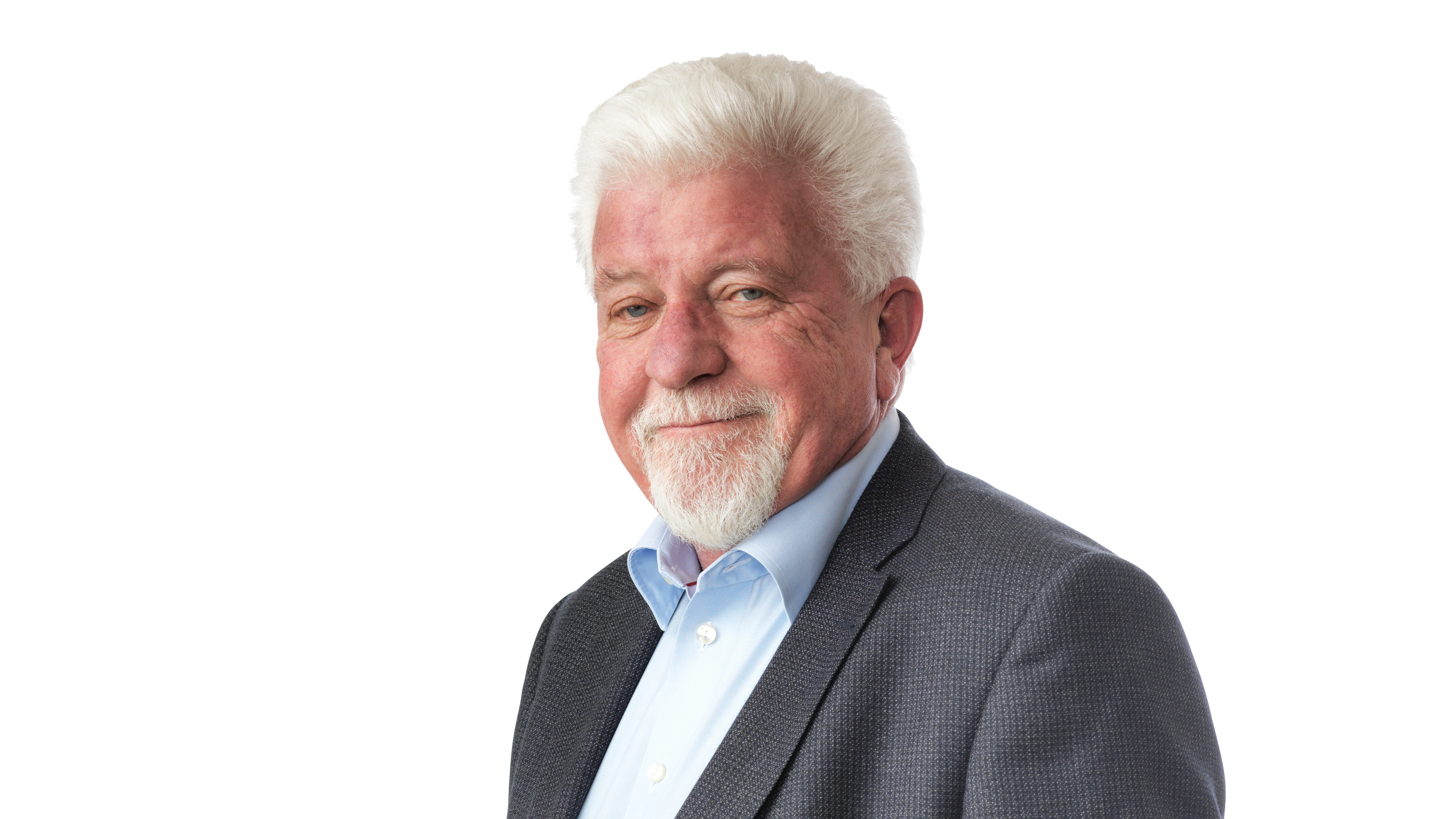 An elderly man in a suit and blue shirt.